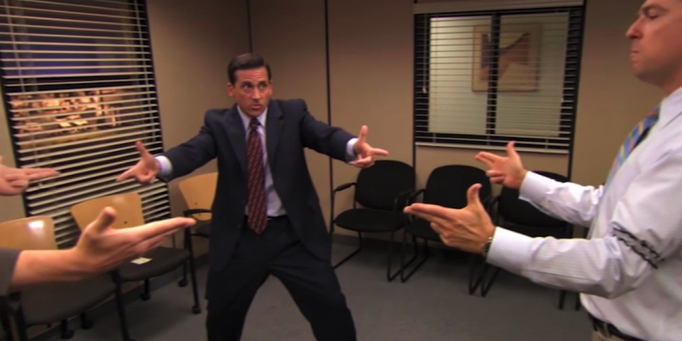 Michael points finger guns at employees in The Office