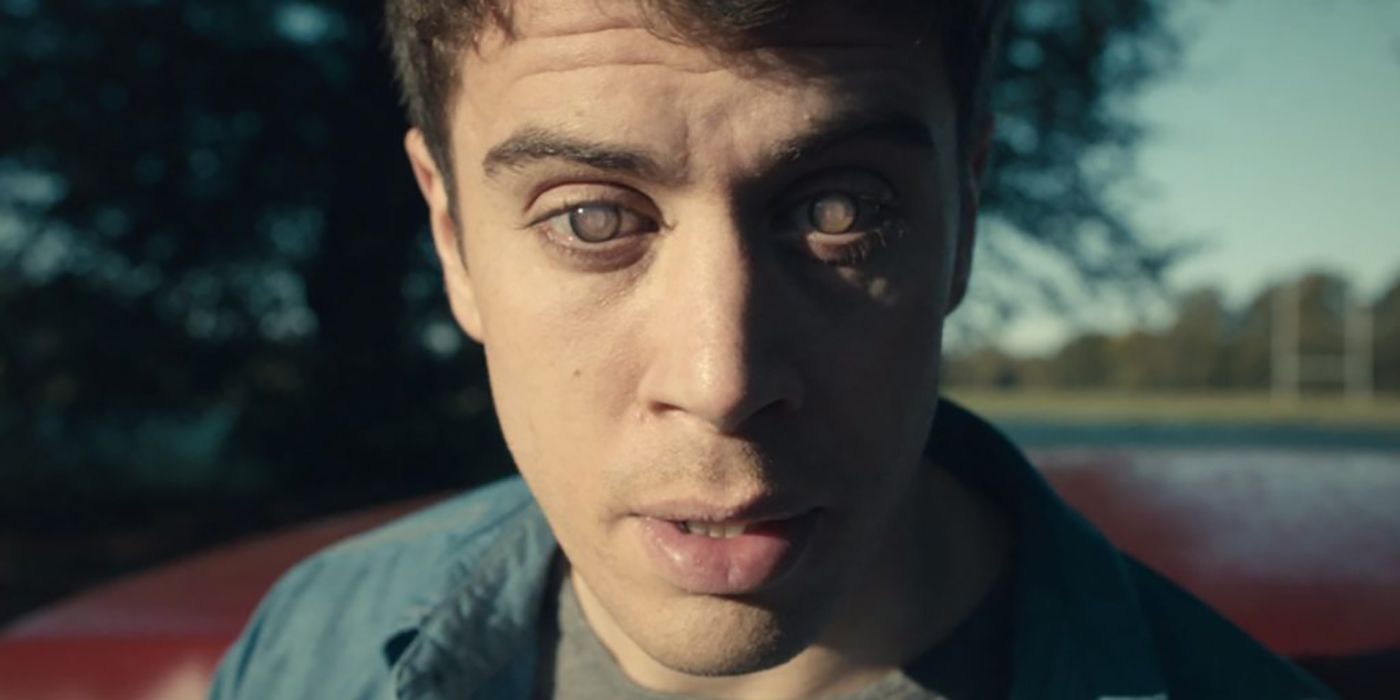 Toby Kebbell staring into the screen, eyes glazed over in a scene from Black Mirror.