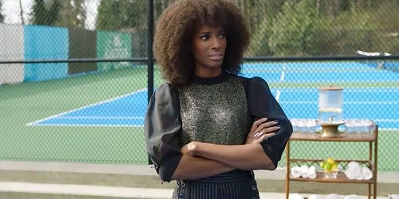 Aleesha from Upload in Lakeview on a tennis court, her arms folded in frustration.