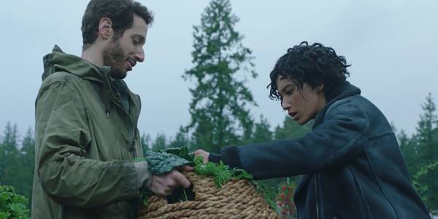 Matteo from Upload holding a basket of vegetables with Nora looking through it.