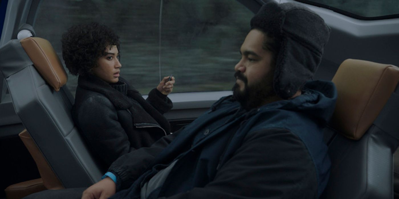 Ivan and Nora sitting across from one another in a self-driving car in a scene from Upload.
