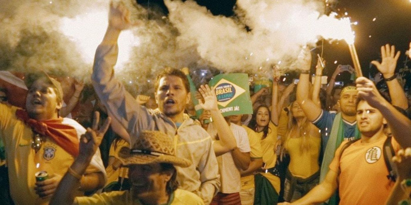 Protesters hold signs and Brazilian flags in The Edge Of Democracy