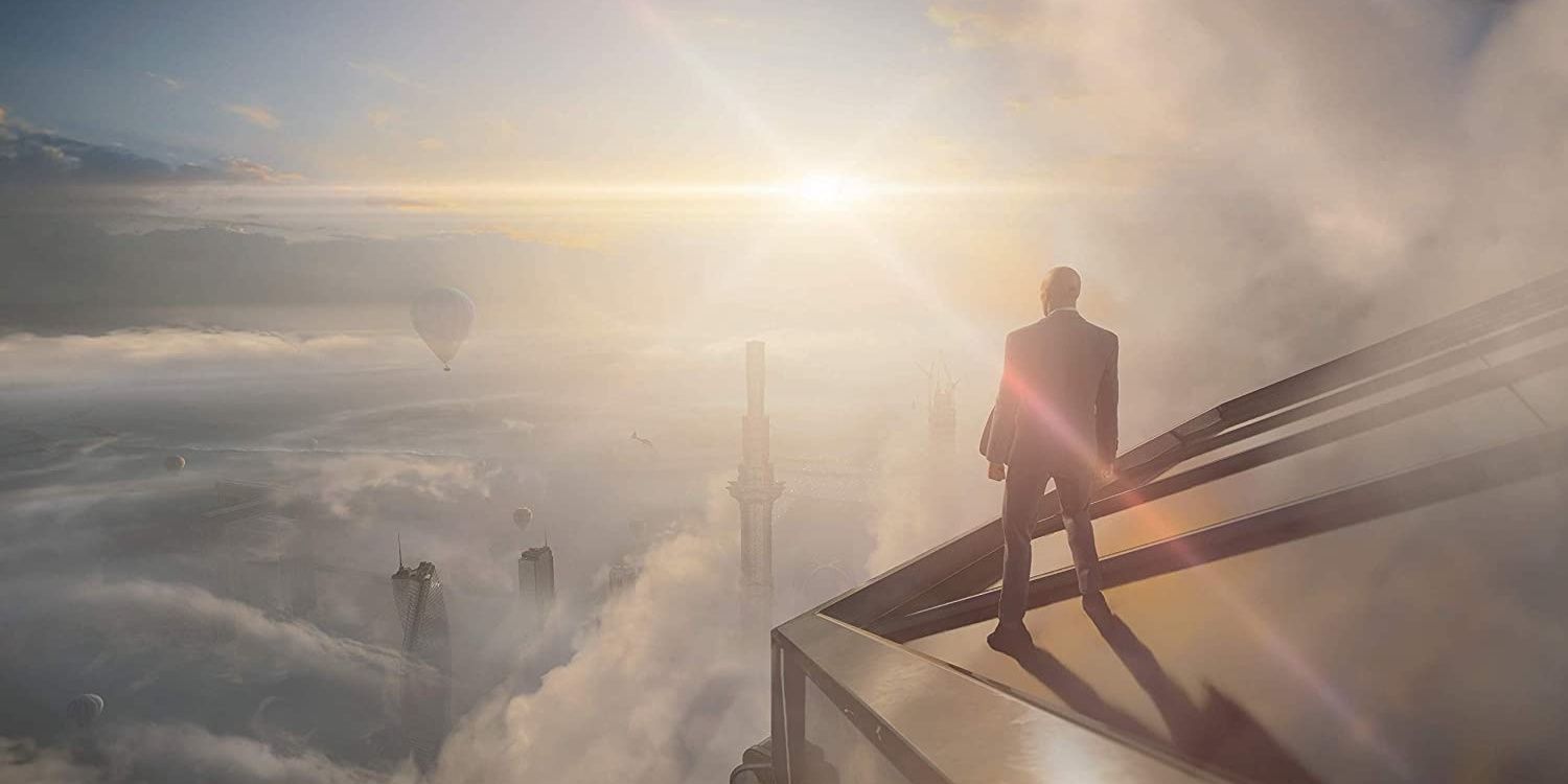 Agent 47 looks at the Dubai skyline in Hitman 3