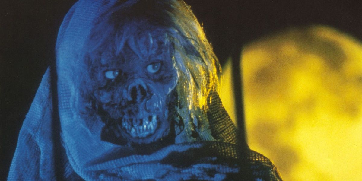 An undead creature sitting in a still from Creepshow 