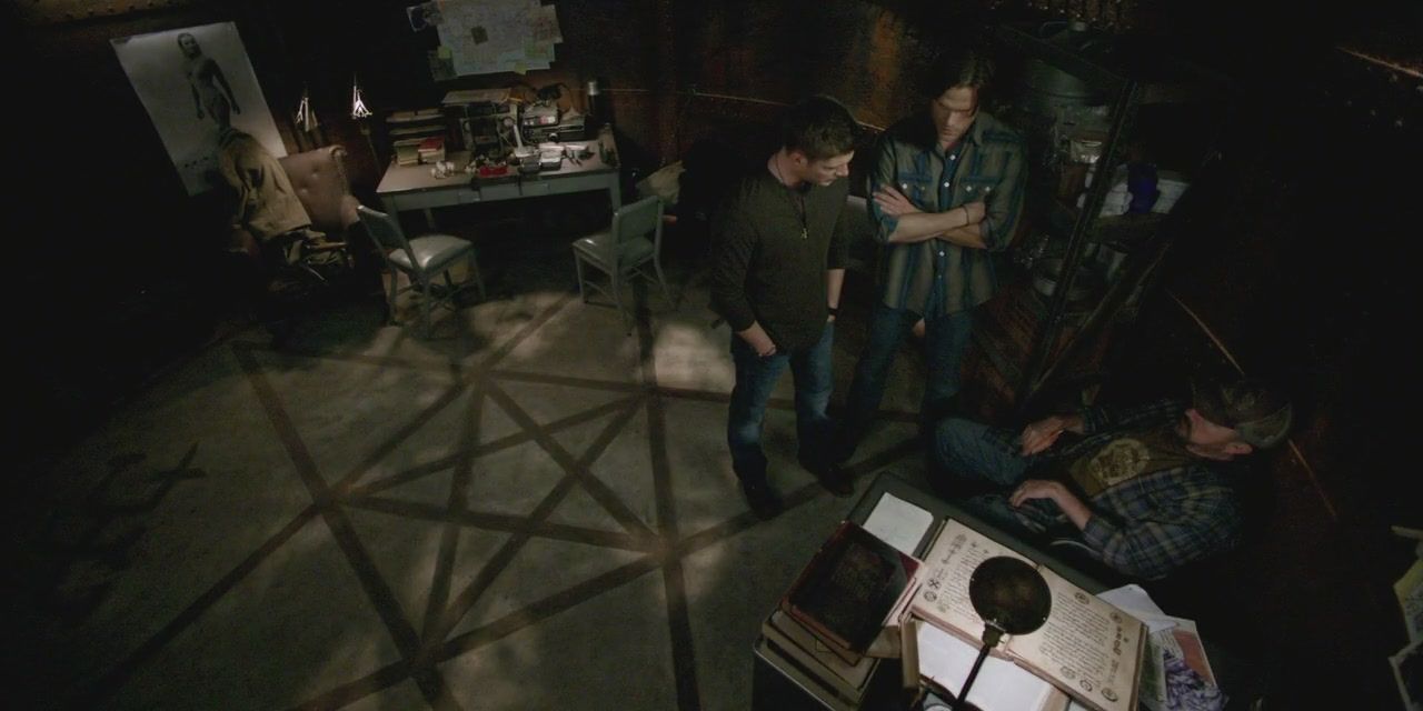 Bobby, Sam and Dean researching in Bobby's panic room