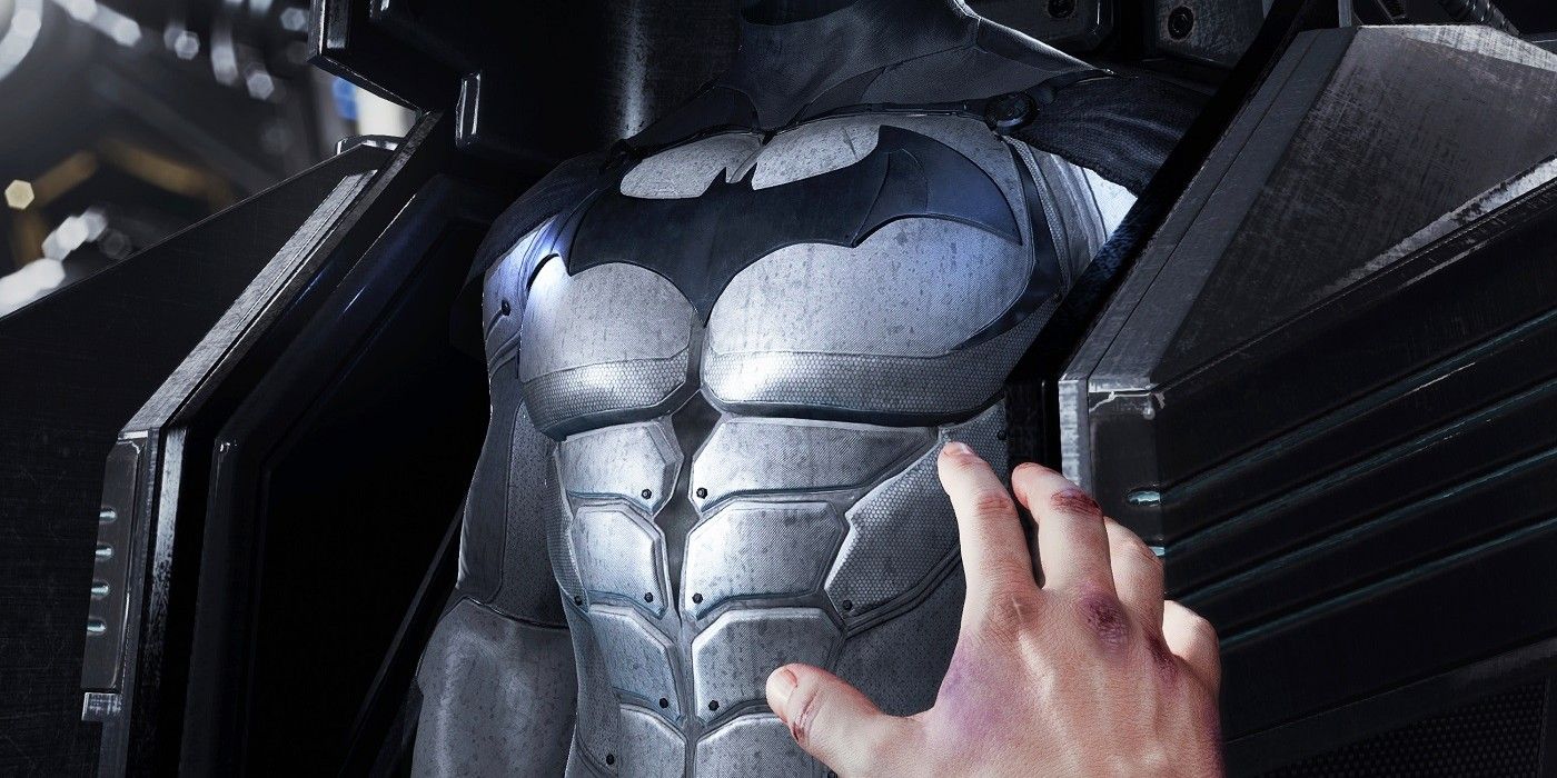 A hand reaching for the bat suit in Batman Arkham VR
