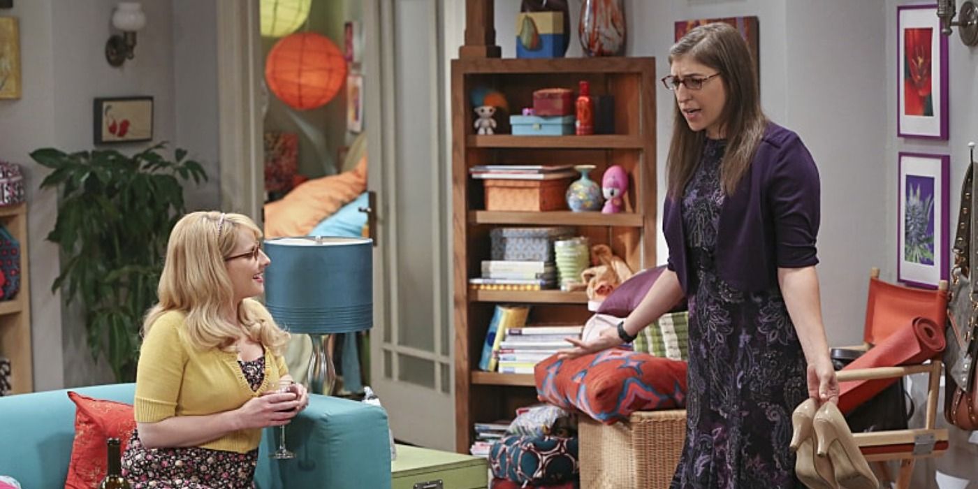 Bernadette on couch and Amy holding shoes in The Big Bang Theory season 9