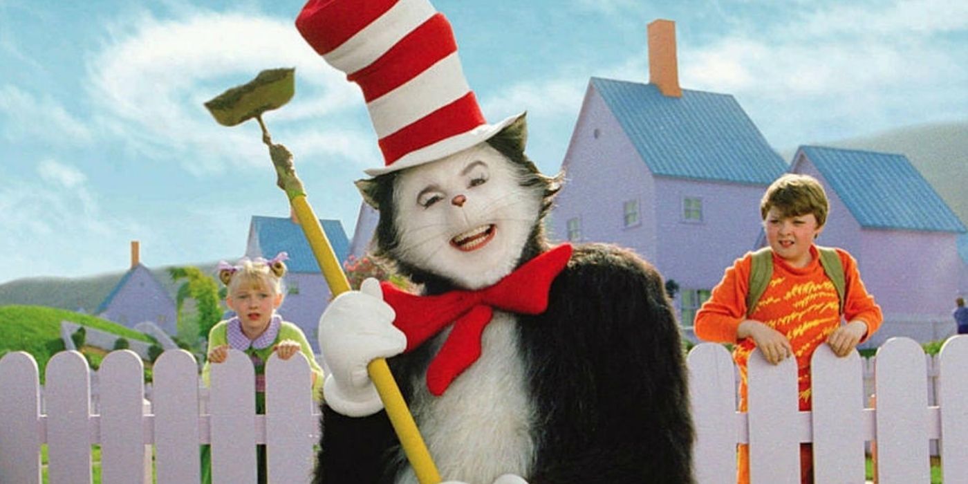 2 kids watching the Cat In The Hat holding a garden hoe from over their white picket fence