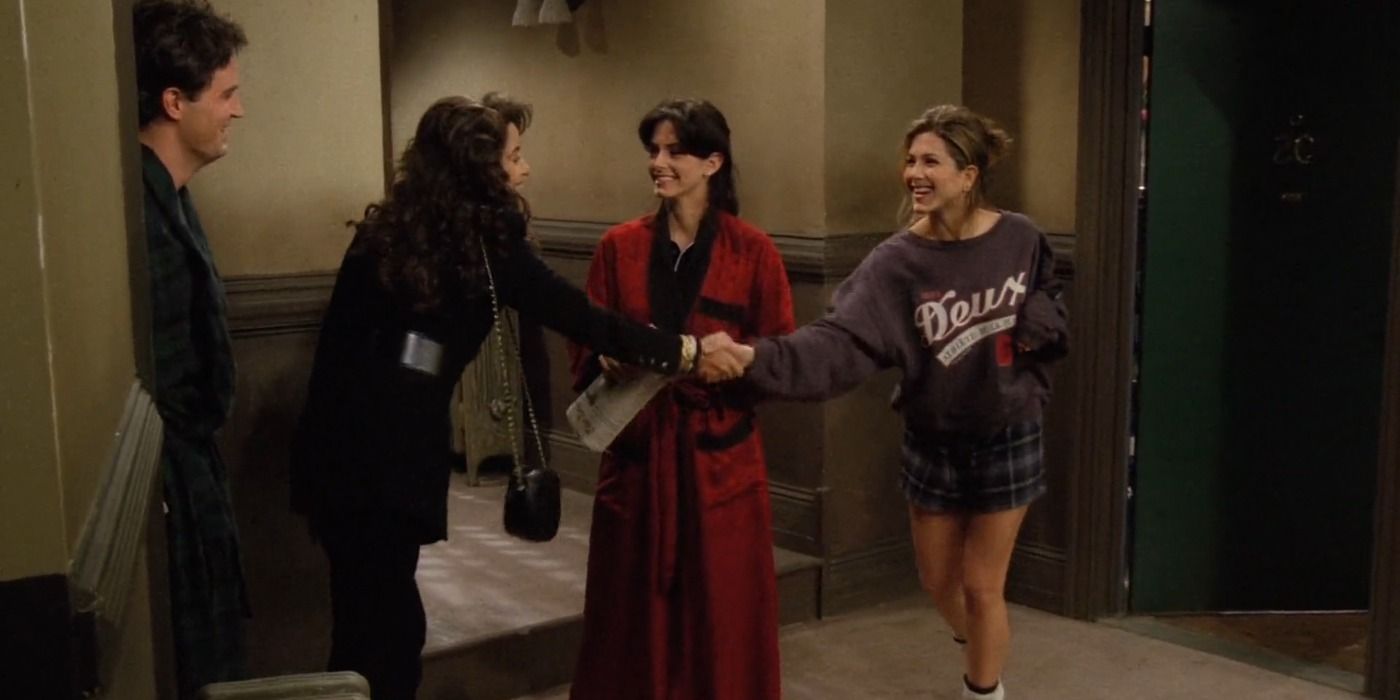 Chandler and Janice talking to Monica and Rachel in the hallway in Friends