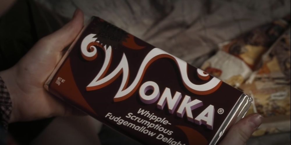 Charlie holds a Wonka Bar in Charlie and the Chocolate Factory
