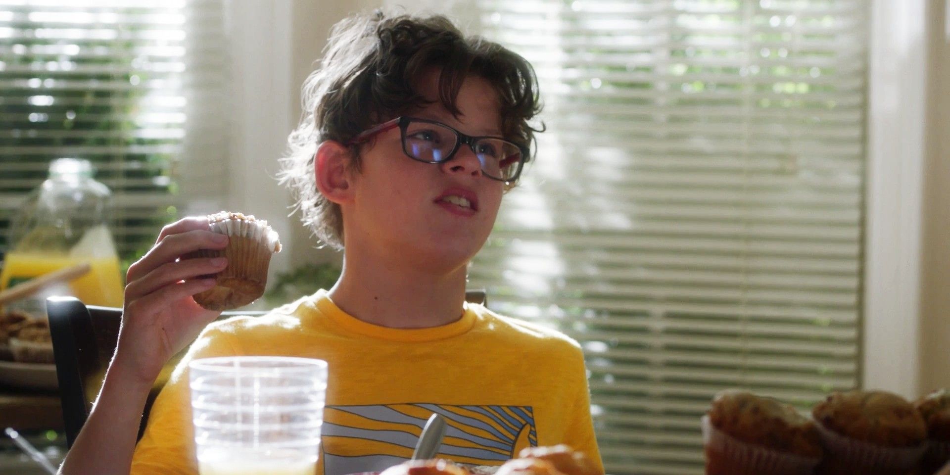 Christopher Diaz (Gavin McHugh) holds muffin at breakfast table in 9-1-1