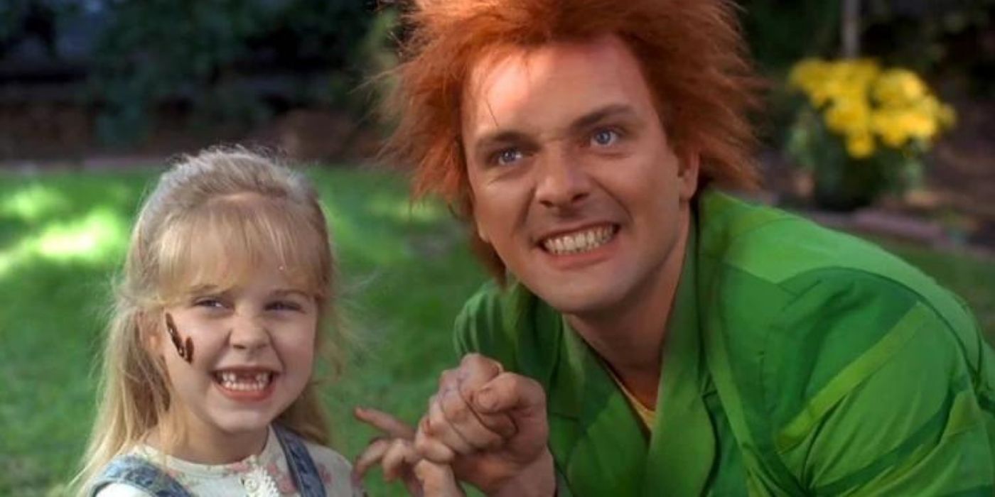 A little girl with missing front teeth pinky promising with a man in a green suit and red hair