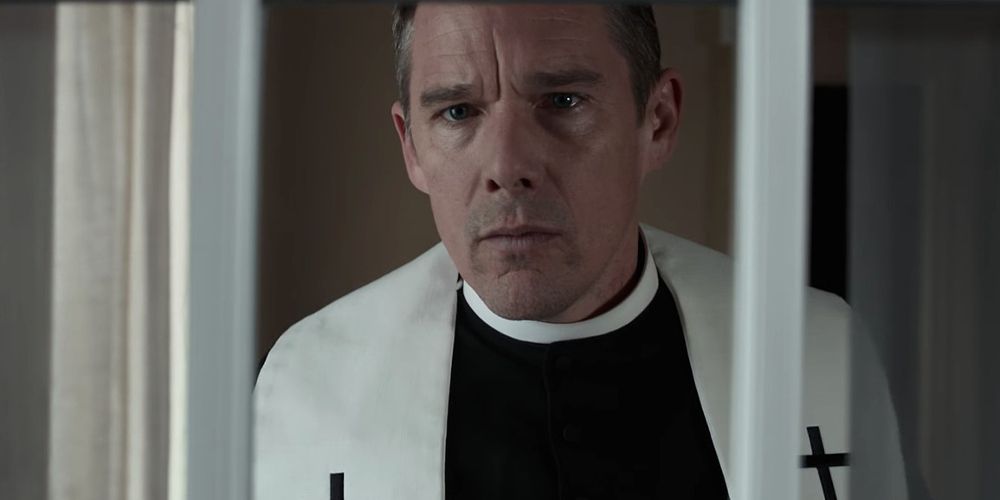 Erns leans out of a window in First Reformed