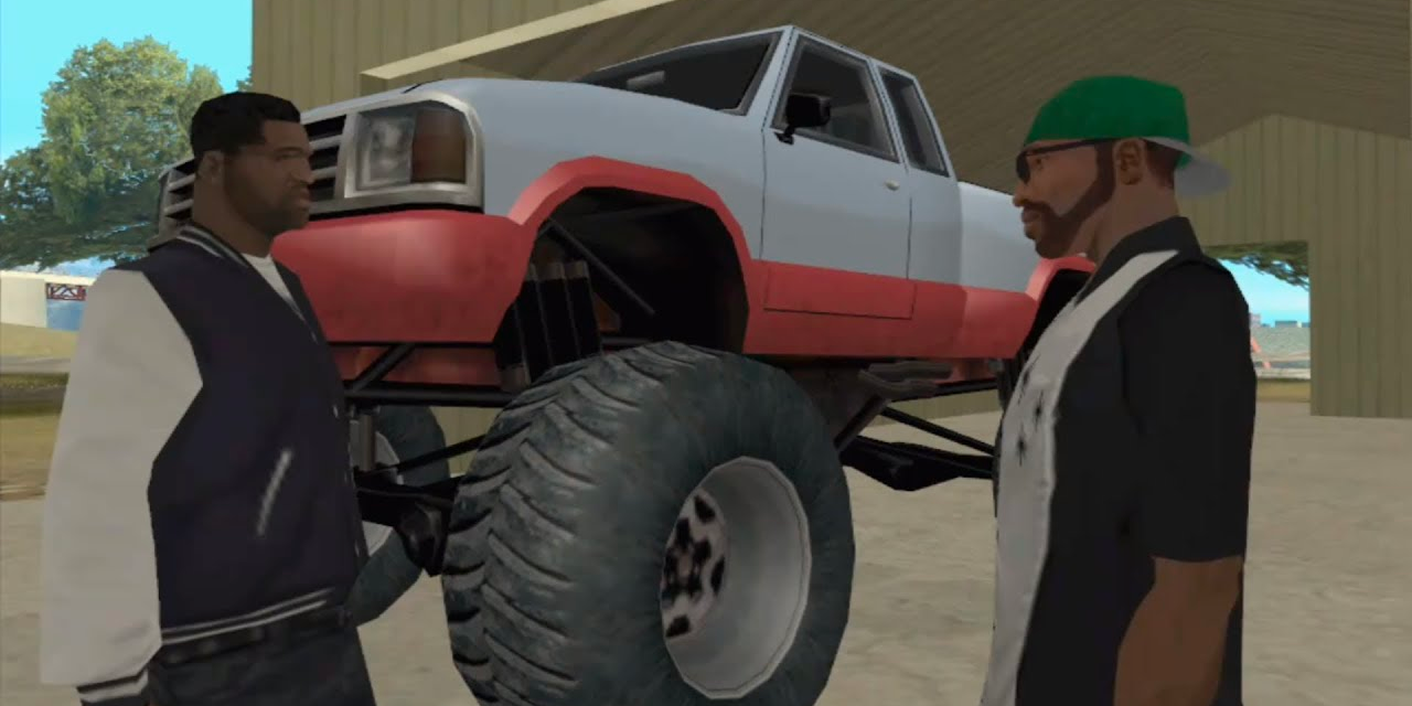 CJ talks to someone in front of a monster truck