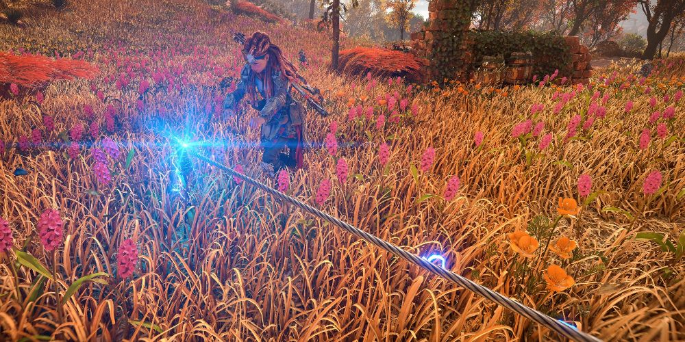 Aloy sets a tripwire in Horizon Forbidden West