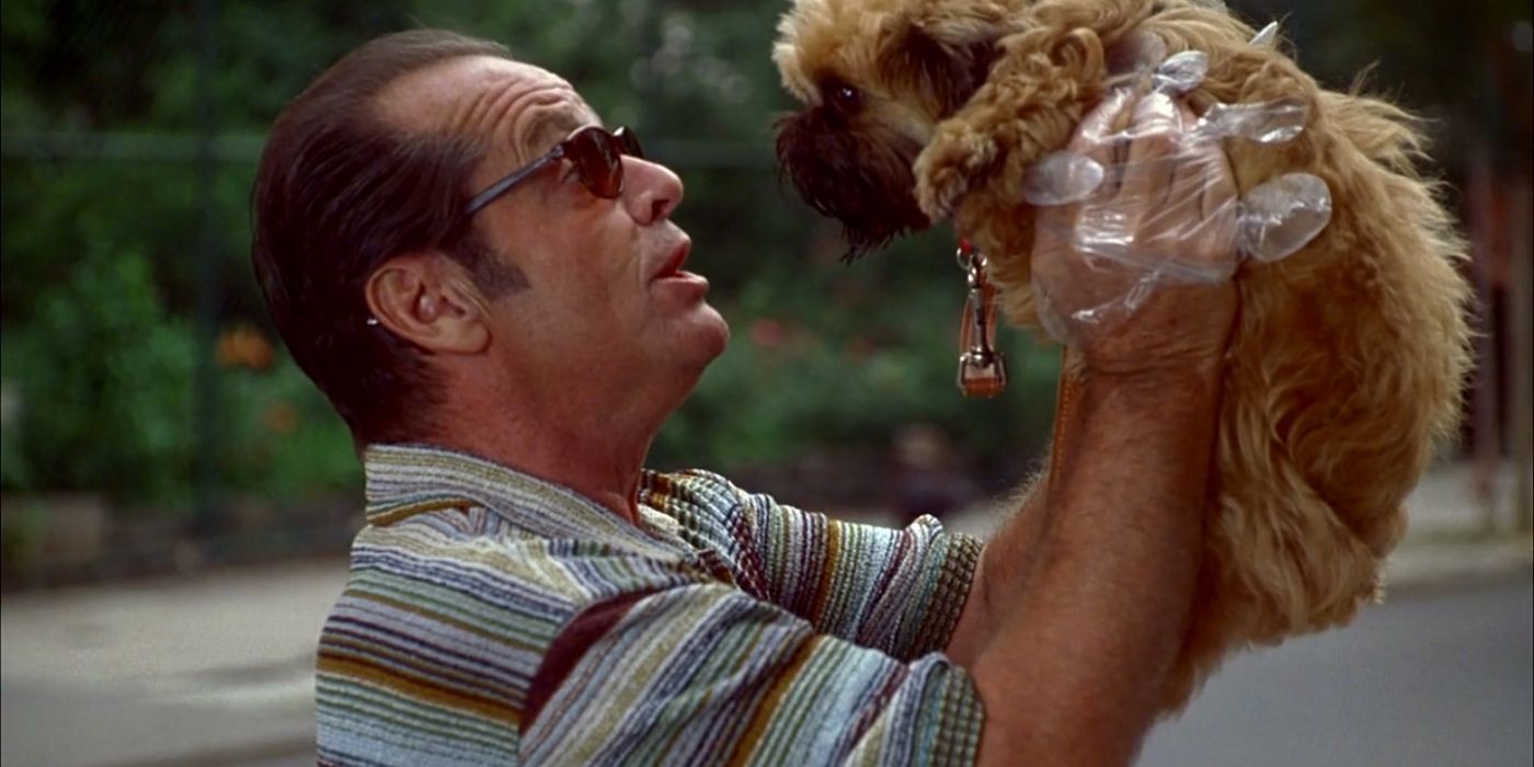 Jack Nicholson Holding Up A Little Dog In As Good As It Gets