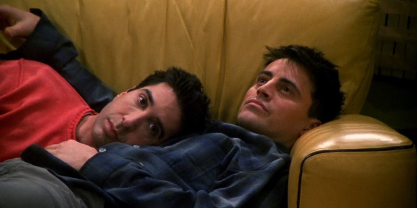 Joey and Ross nap together on a couch in Friends