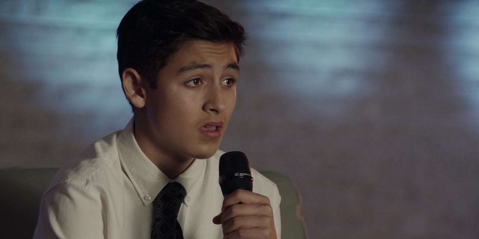 Marcel Ruiz speaking into a microphone in Breakthrough