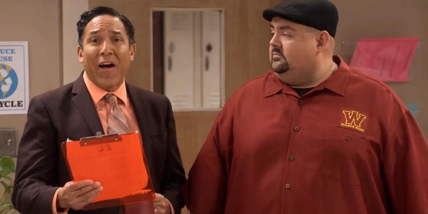 Carlos standing with a clipboard next to Gabriel in Mr. Iglesias.