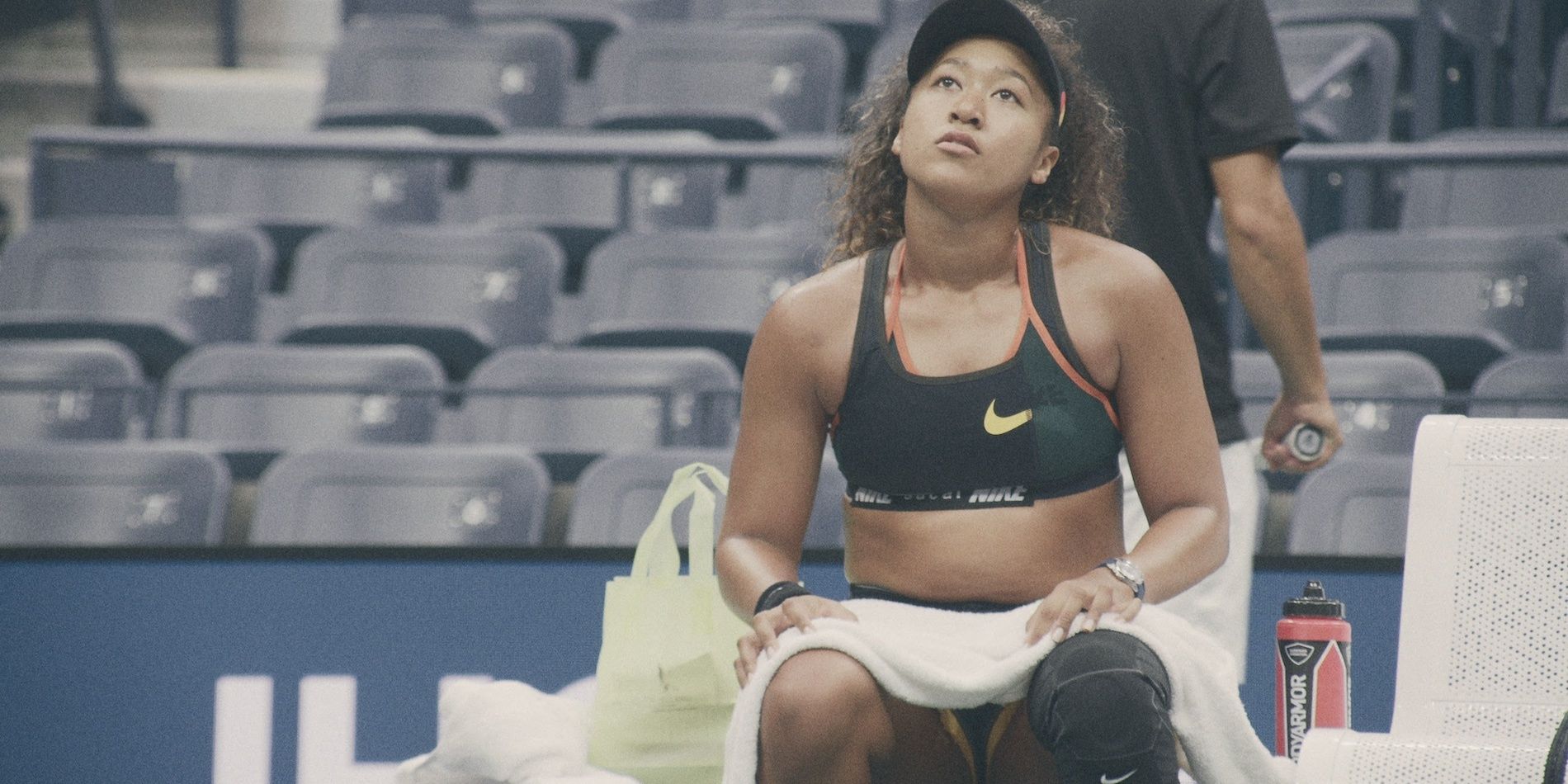 Naomi Osaka takes a rest during a training session in her docuseries
