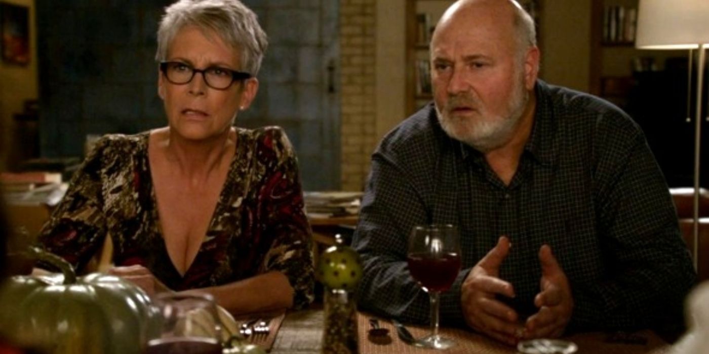Joan and Bob sitting at the Thanksgiving table on New Girl