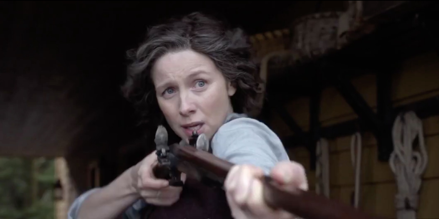 Claire aiming a gun on Outlander