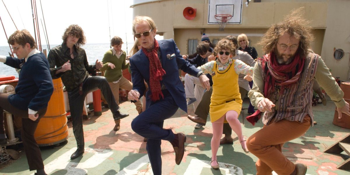 A bunch of people dance to music on the deck of a ship from Pirate Radio