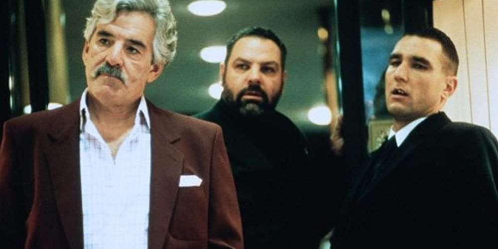 Dennis Farina, Vinny Jones, and Sam Douglas standing in Snatch