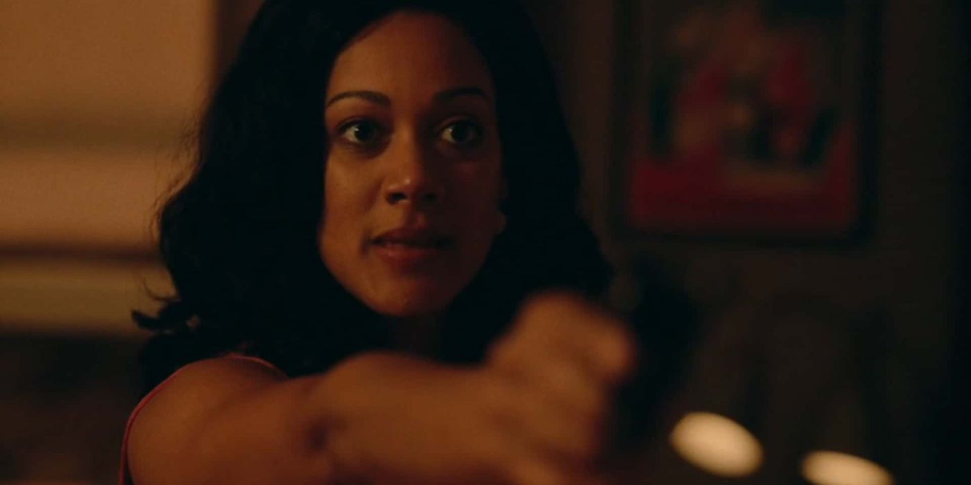 Sensia pointing a gun in The Last Days Of Ptolemy Grey.