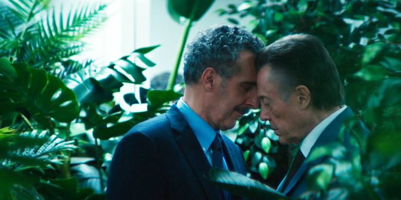 Irving and Burt touching foreheads in Severance while surrounded by plants