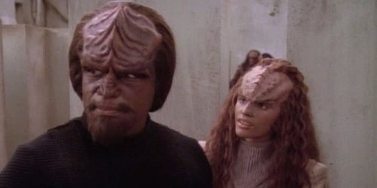 Worf looks away as another Klingon speaks to him from Birthright 