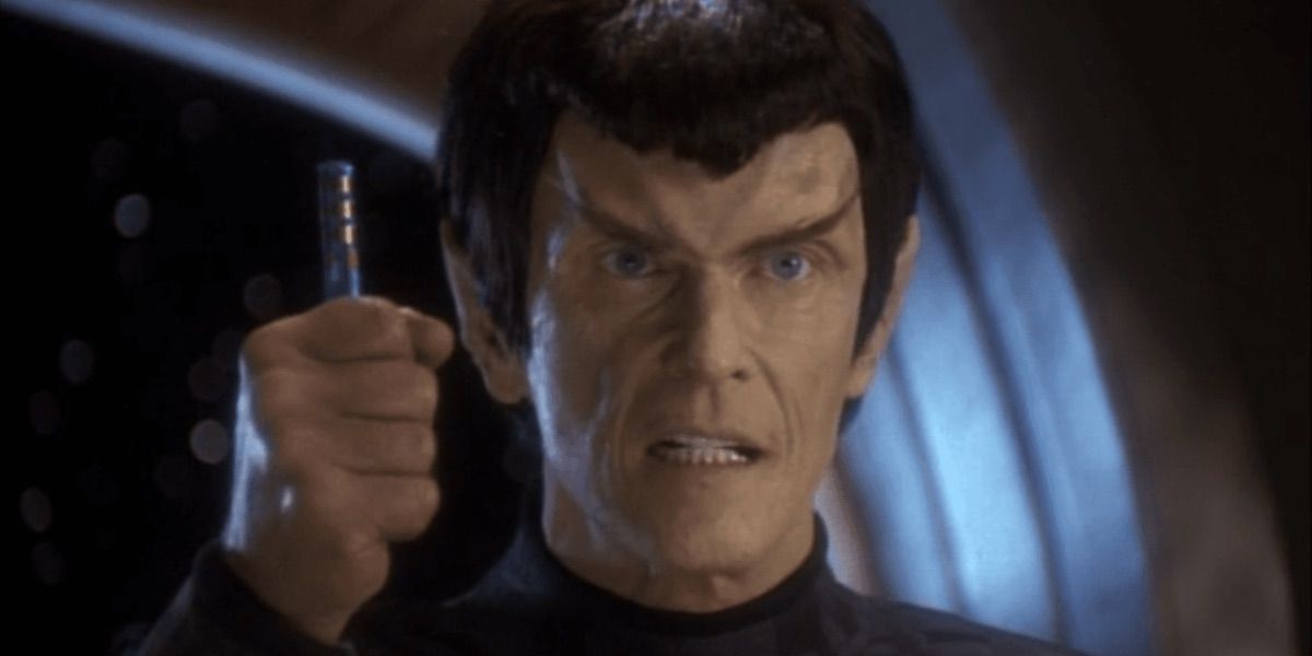 A Romulan angrily holds up a data chip from In the Pale Moonlight 