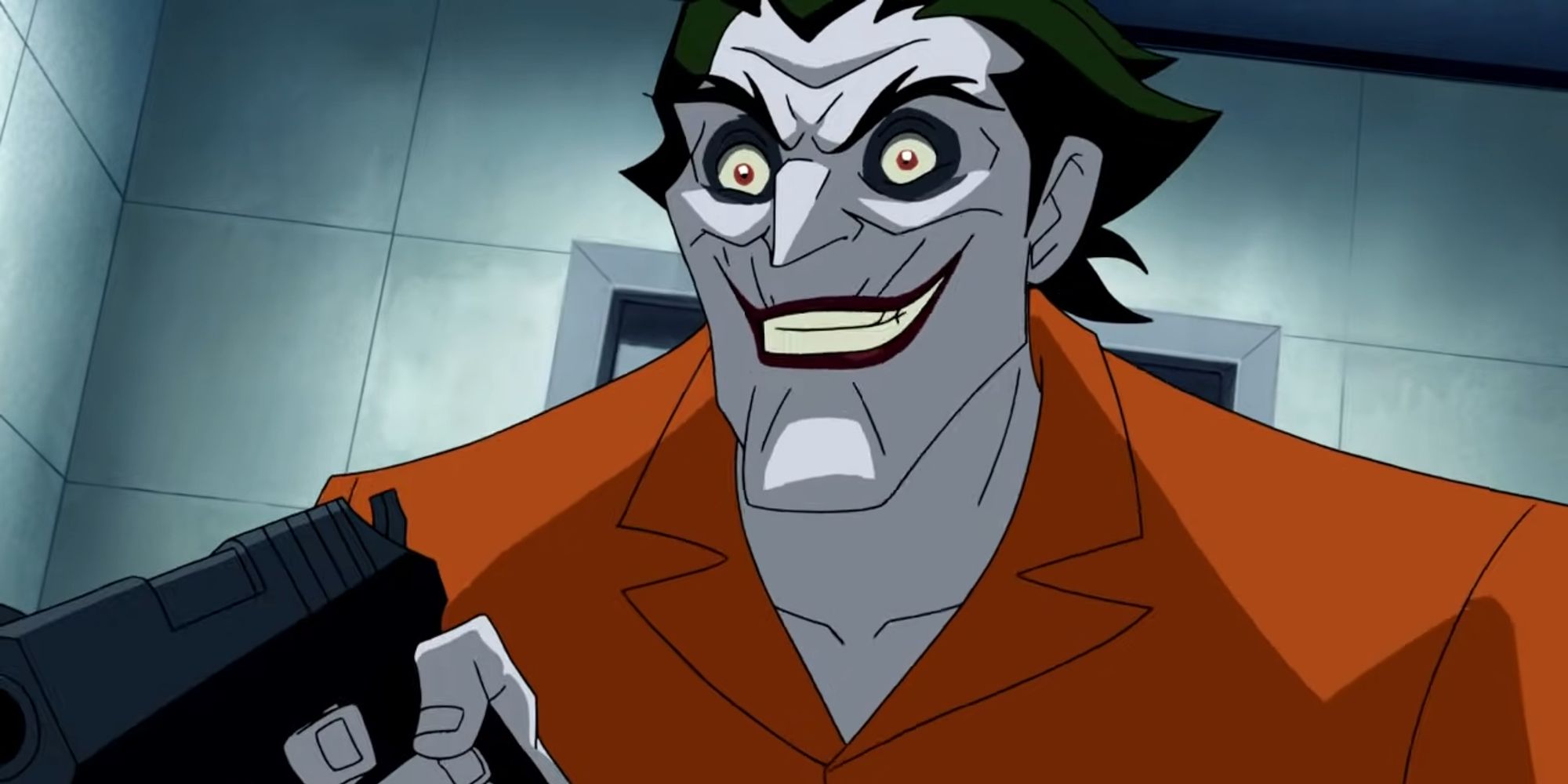 The Joker in his cell with a gun in Batman Under The Red Hood