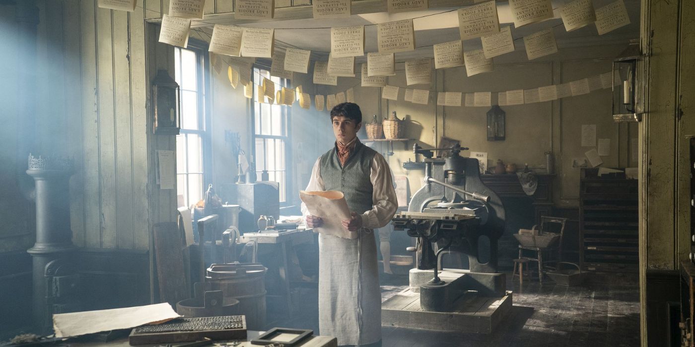 Theo standing in the printing shop on Bridgerton