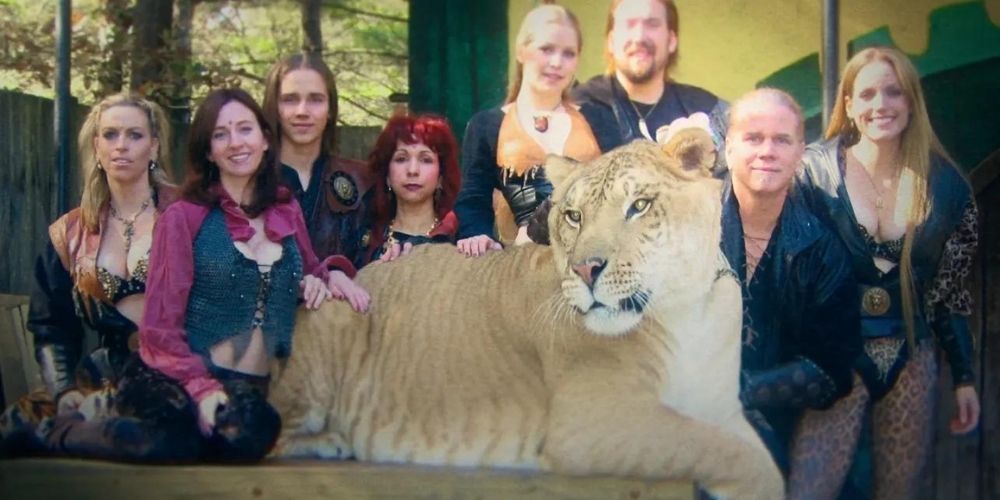 Doc Antle and a bunch of women pose with a tiger in Tiger King