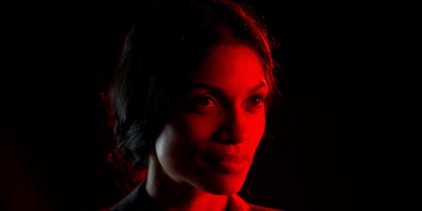 Rosario Dawson bathed in red light