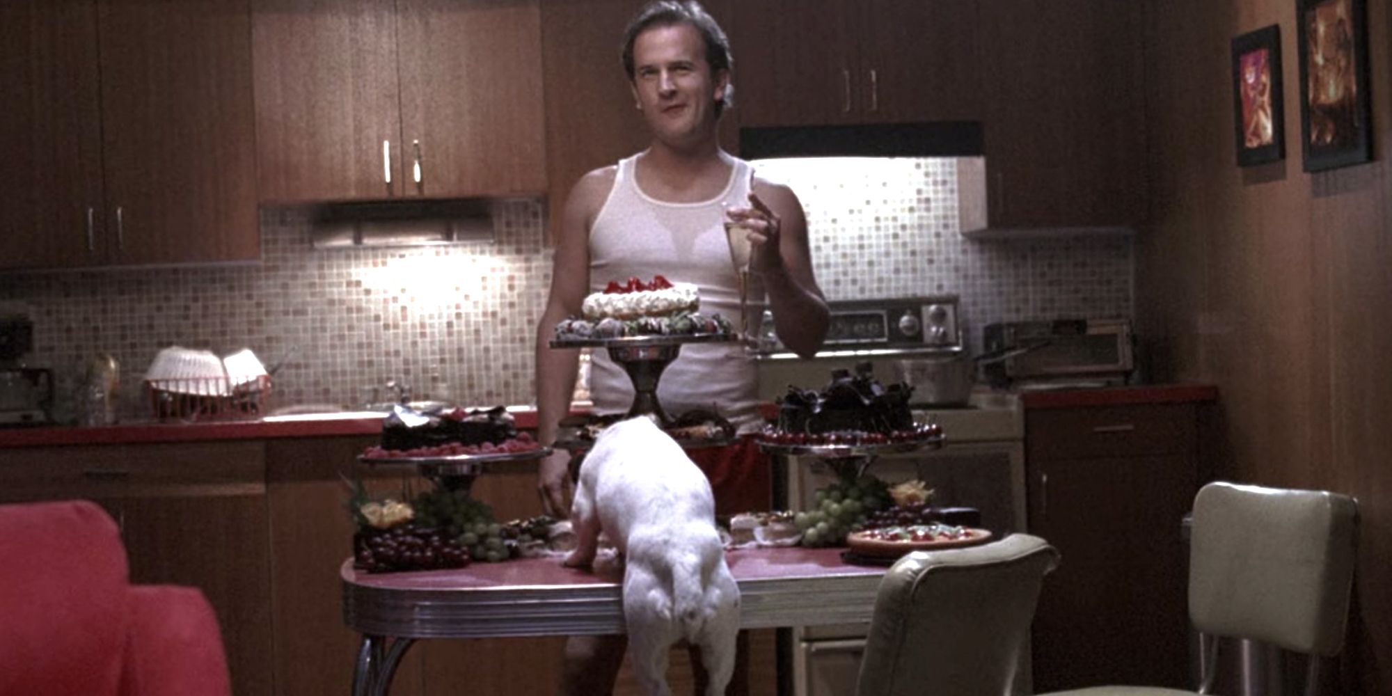 Image of the Trickster/Gabriel in his underwear eating a banquet of food with a dog
