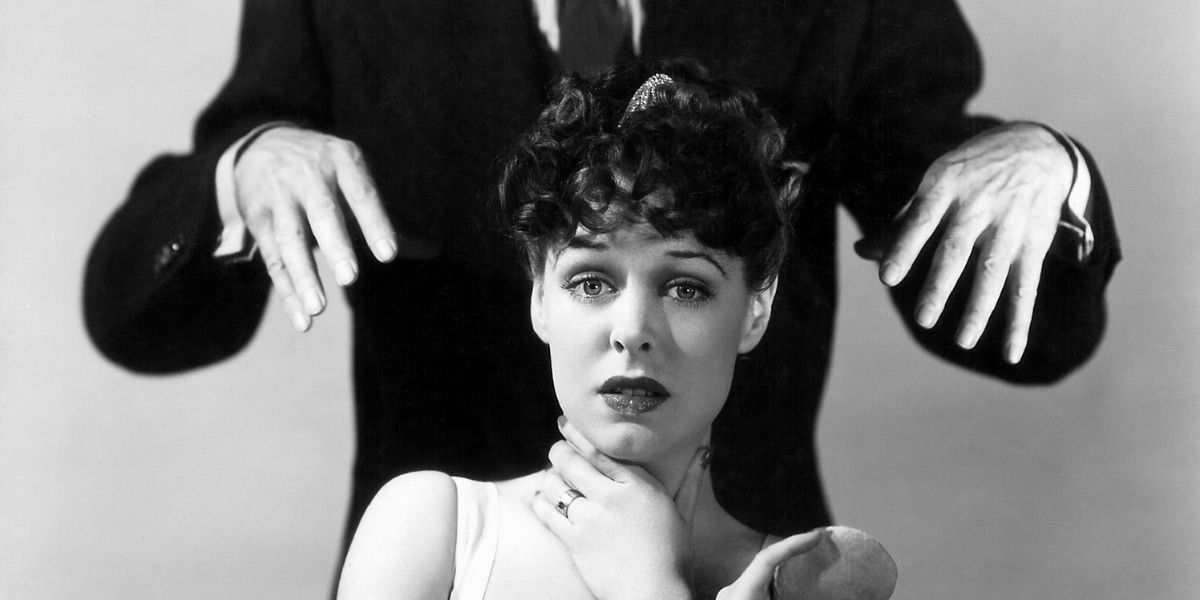 A woman looks concerned as a pair of hands reach over her from Black Friday