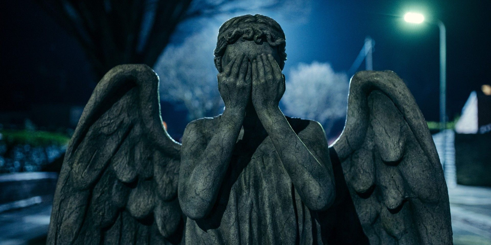 Weeping Angel with its hands over its face in the dark