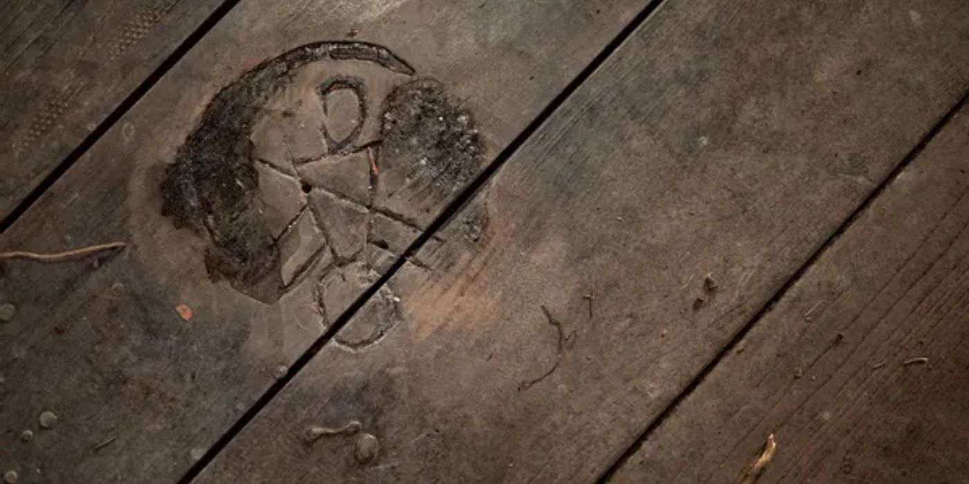 Yellowjackets Symbol carved into a floorboard