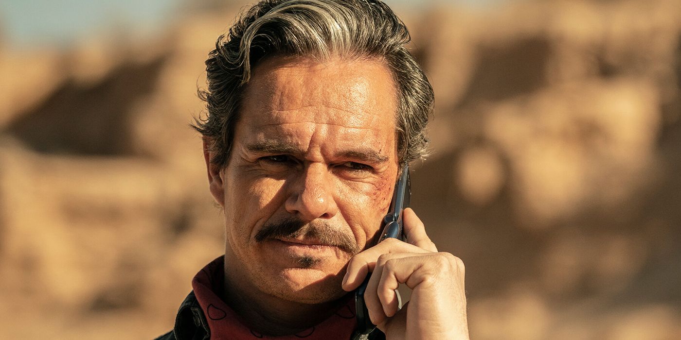 Lalo outside in the sun, talking on the phone in a scene from Better Call Saul.