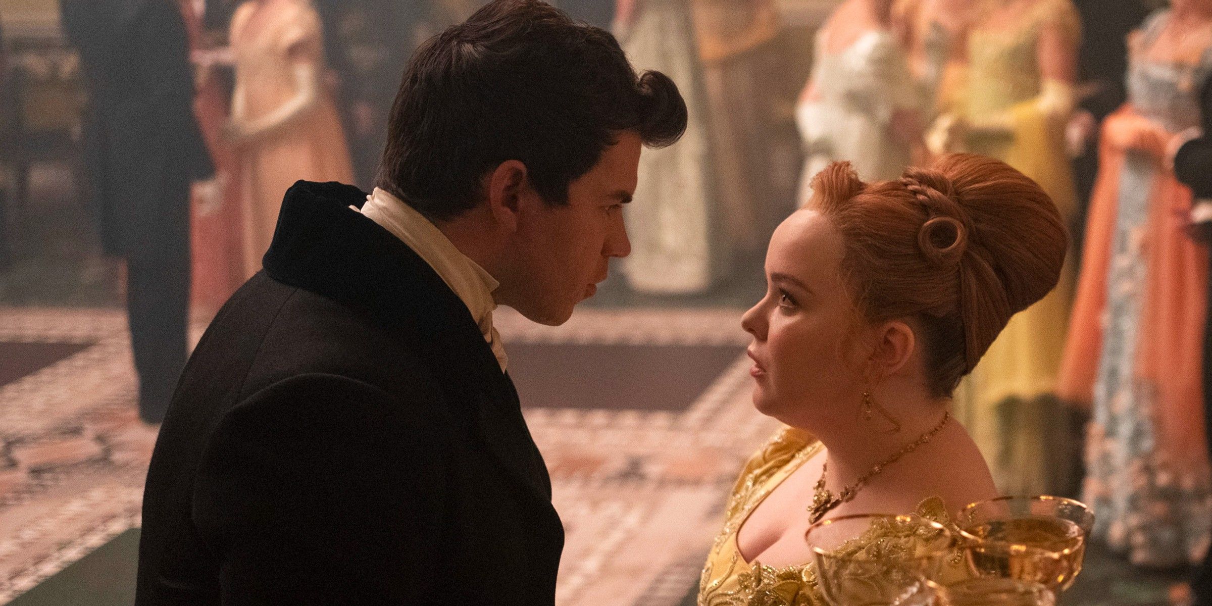 Colin and Penelope staring intensely at each other at a ball on Bridgerton