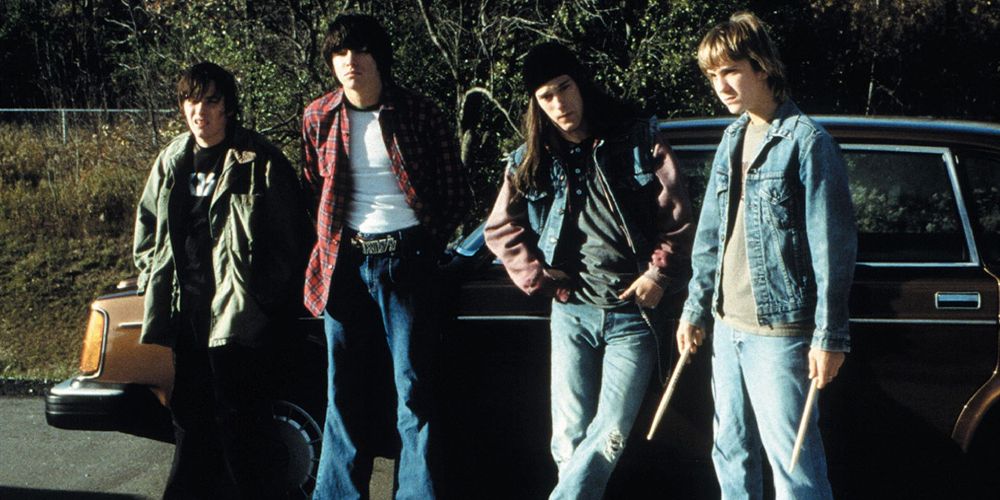 Hawk, Lex, Trip and Jam stand by a car in Detroit Rock City