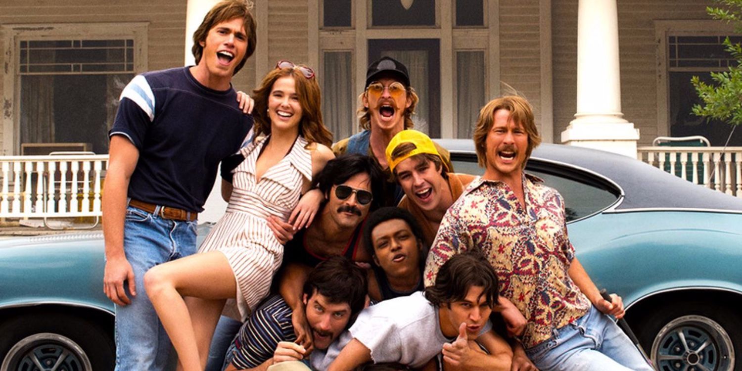 The cast of Everybody Wants Some!! posing by a car