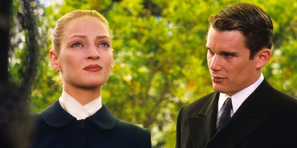 Irene and Vincent stand together by trees in Gattaca