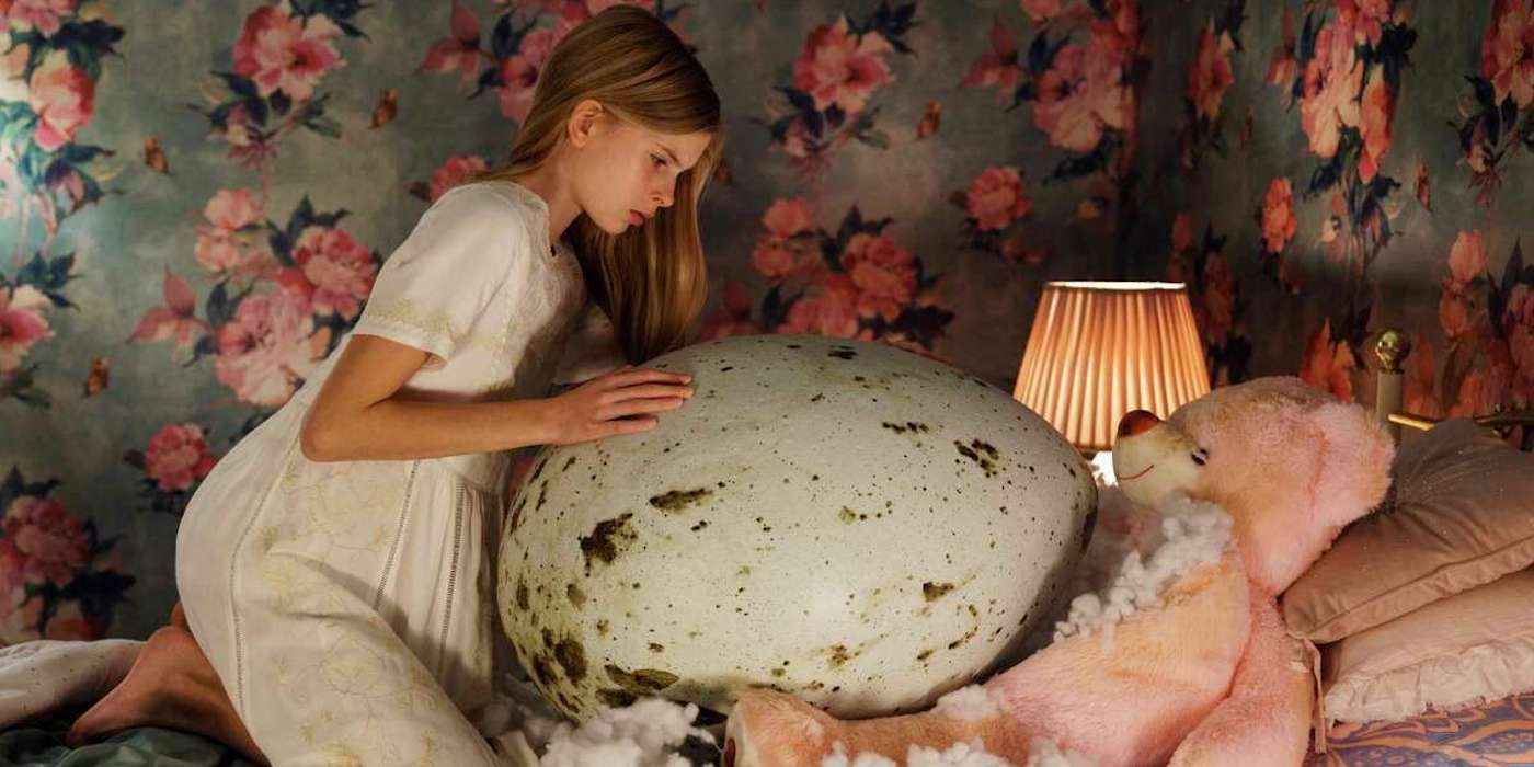 A young girl with a giant egg in Hatching