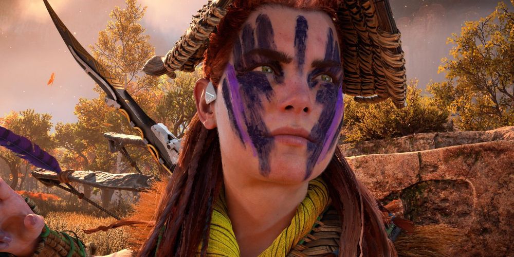 Aloy wears a hat and face paint in Horizon Forbidden West