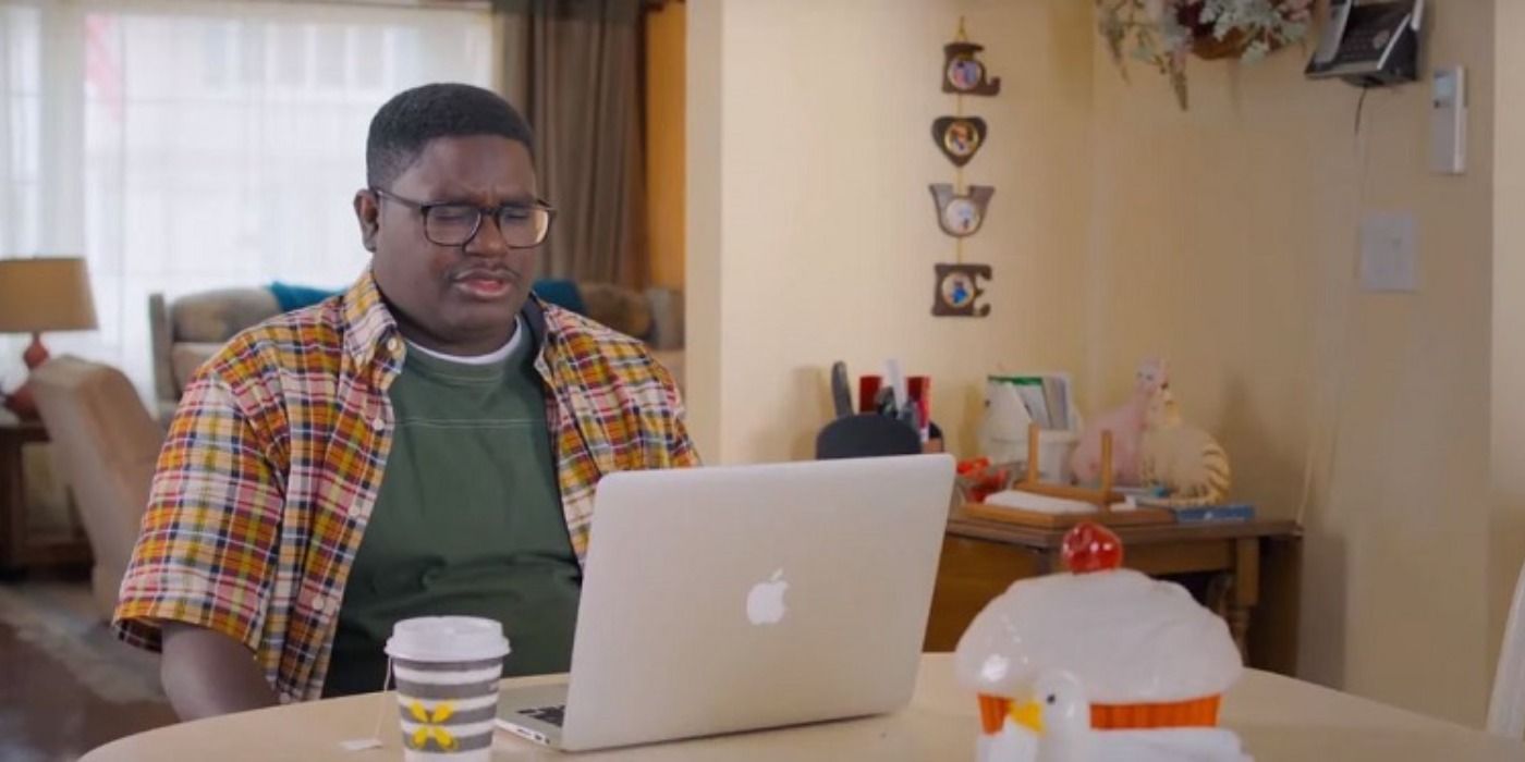 Lil Rel Howery sitting in front of a macbook in Brittany Runs A Marathon.