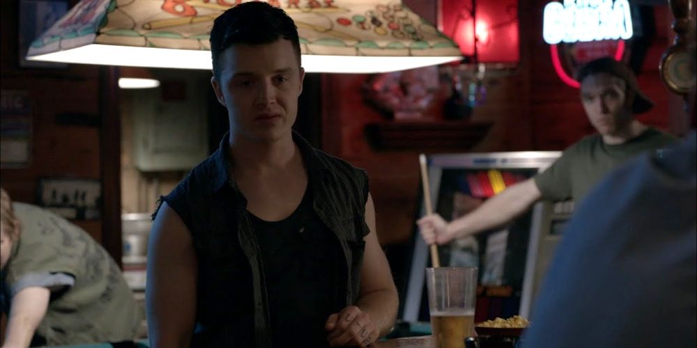 Mickey stands in the bar in Shameless