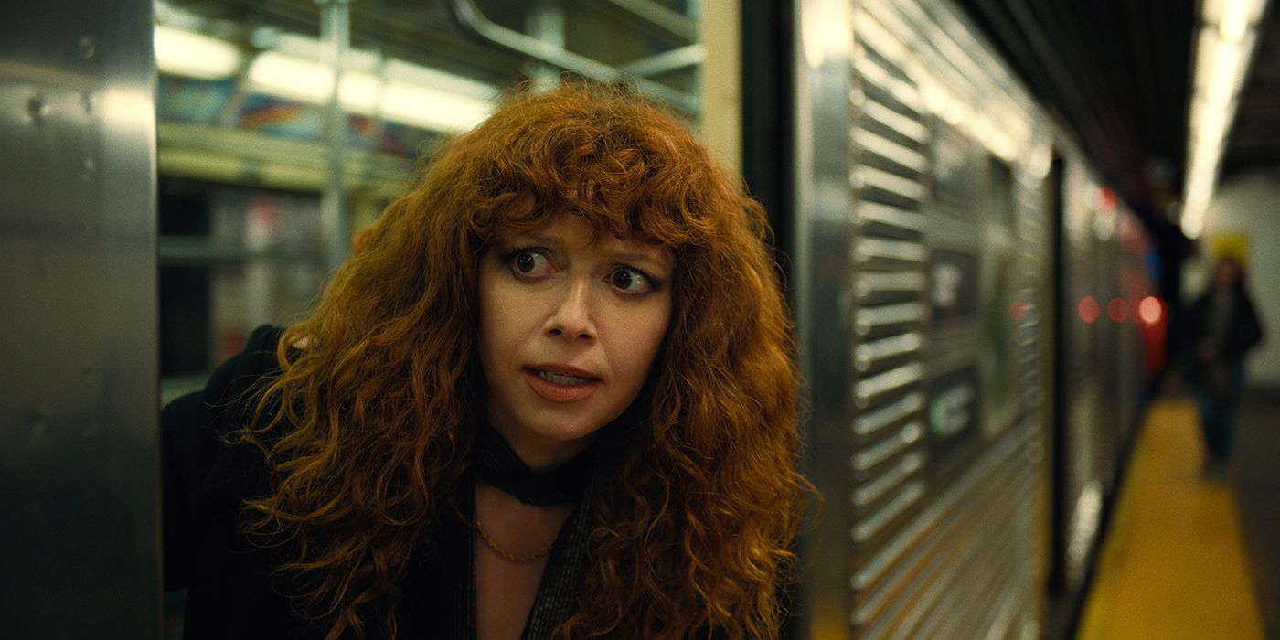 Natasha Lyonne as Nadya, peering out of the doors on a subway train in Russian Doll.